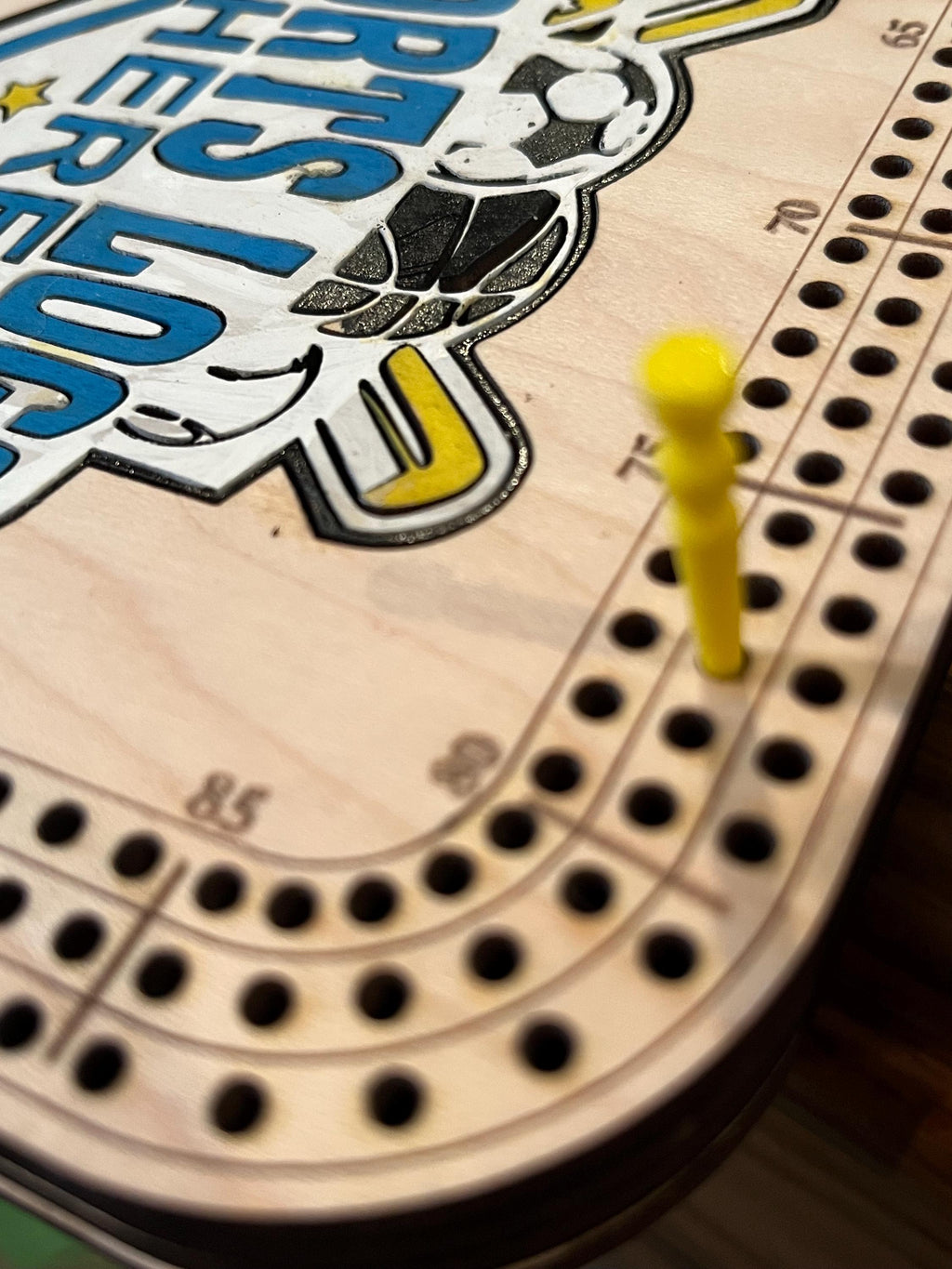 cribbage board with painted logo